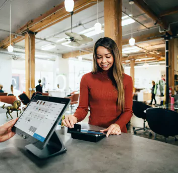 A women paying using POS