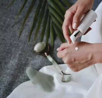A person trying beauty product on hand