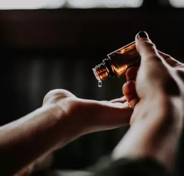 A person hold beauty product bottle on hand