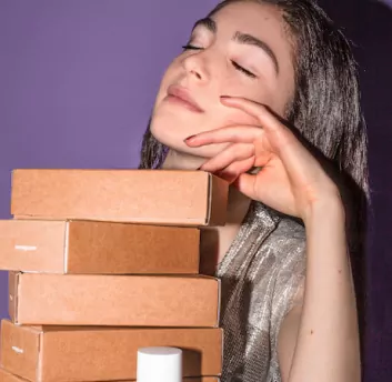 A female sitting in front of product boxes