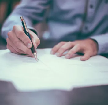 A person writing on papers