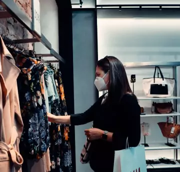 A women is looking at cloths in store