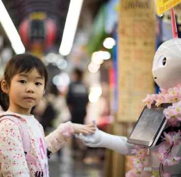 A girl shake hand with robot